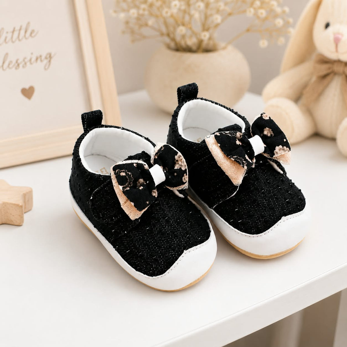 Cute black denim baby sneakers with large bow and white dots for infants and toddlers, soft anti-slip sole