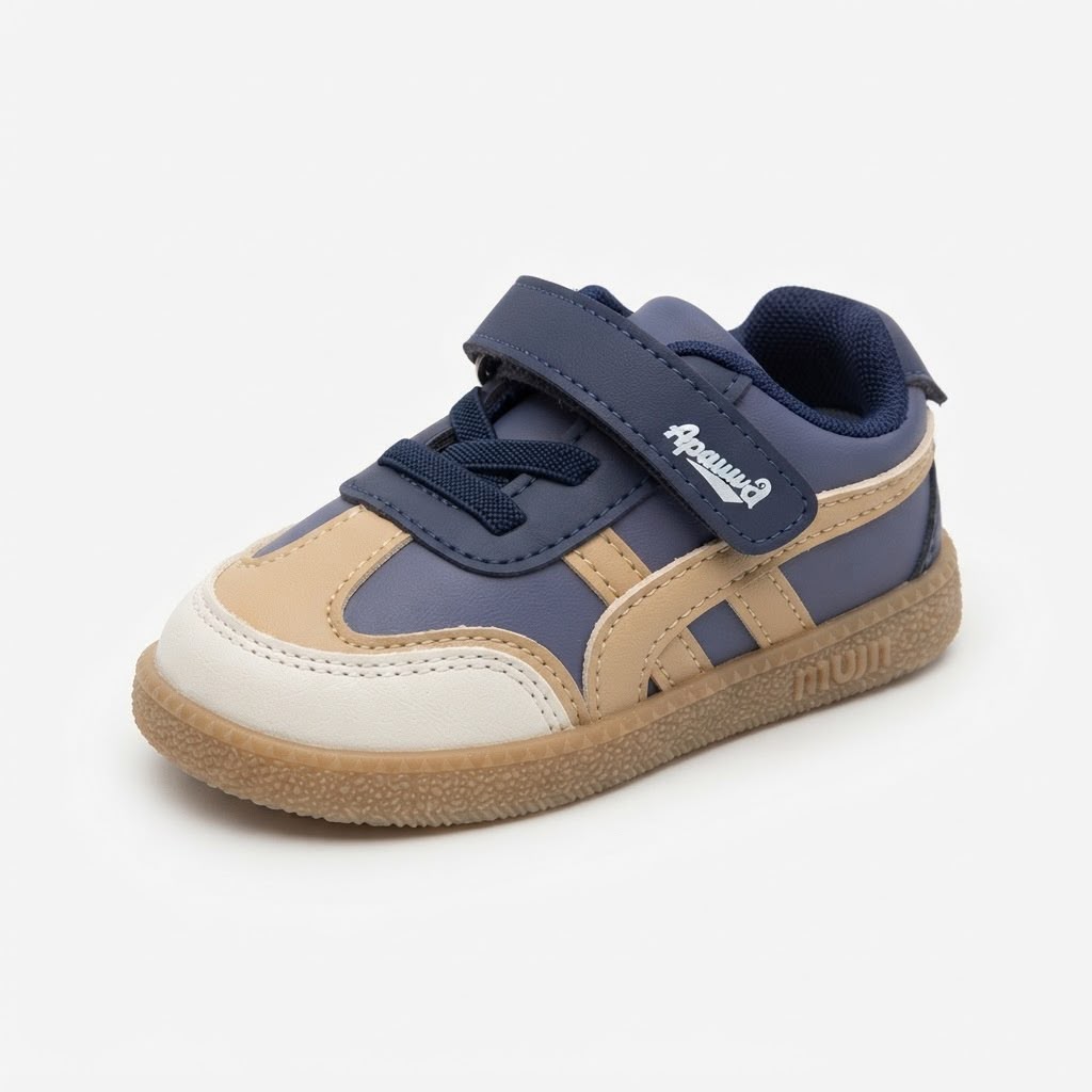 A toddler's low-top sneaker in navy blue, beige, and off-white, featuring a hook-and-loop strap closure with 'Pumapal' branding and a gum sole.