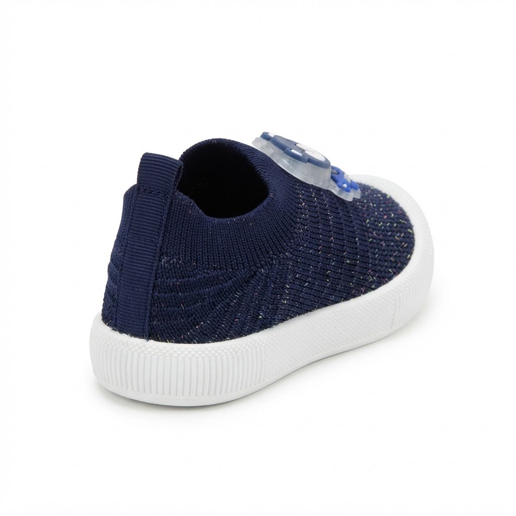 A navy blue knit slip-on shoe with a white sole, shown from a rear three-quarter angle on a white background.