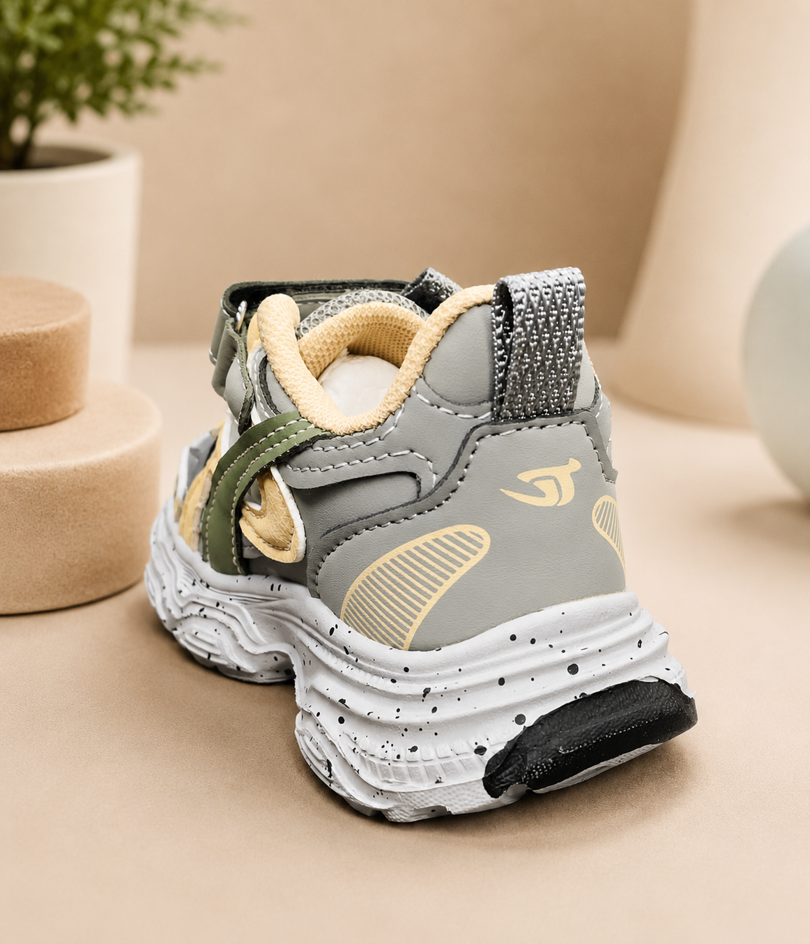 Kids retro chunky sneakers in grey, tan, and dark green with velcro strap, thick rubber sole, and mesh upper.