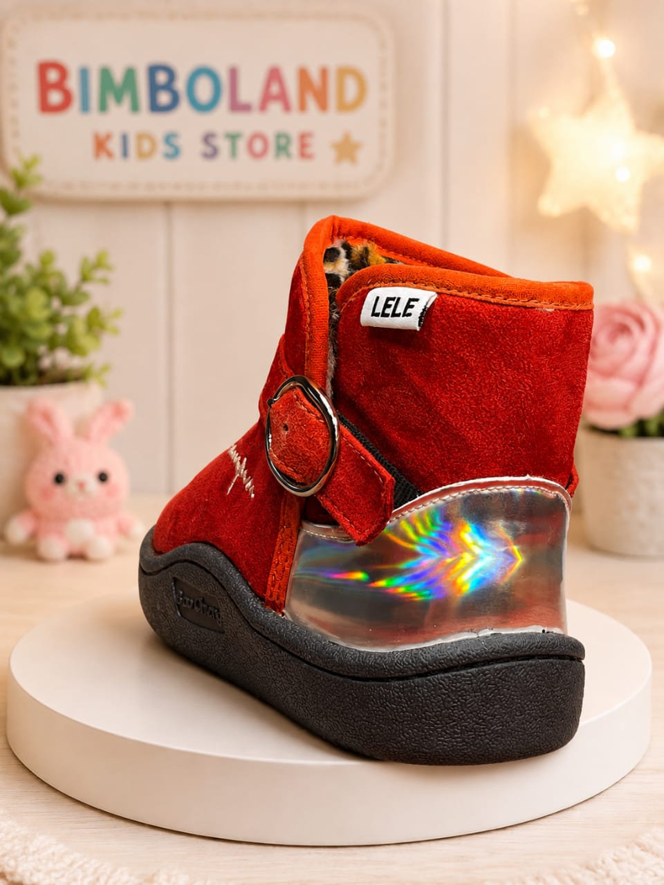 Red suede ankle boots for kids with fur lining, buckle strap, and chunky black sole
